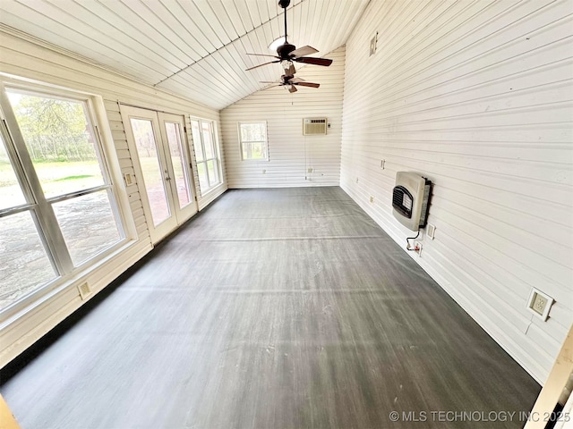 unfurnished sunroom featuring french doors, heating unit, and a wall mounted air conditioner