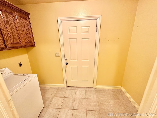 clothes washing area featuring cabinet space, washer / clothes dryer, baseboards, and light tile patterned floors