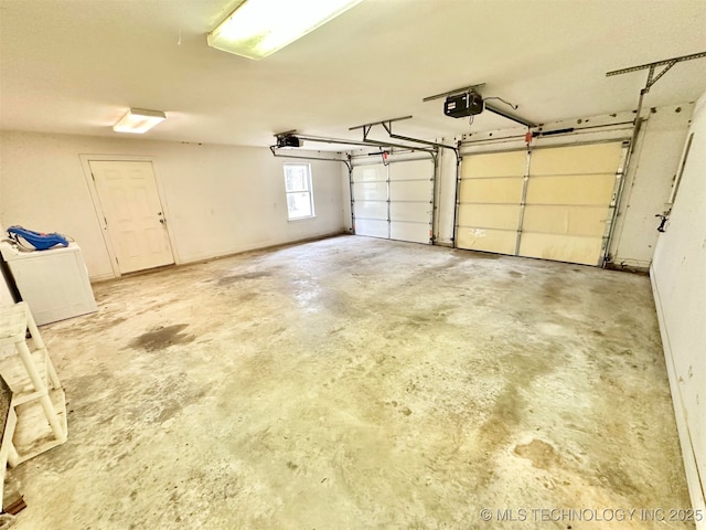 garage with washer / clothes dryer and a garage door opener
