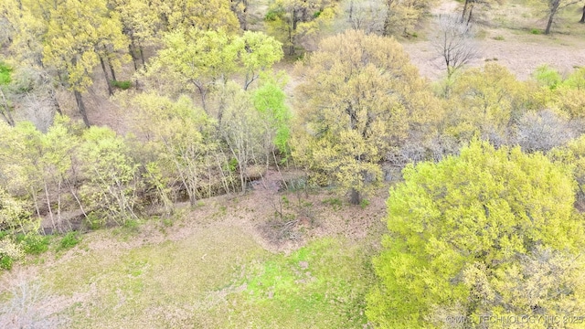 birds eye view of property with a view of trees