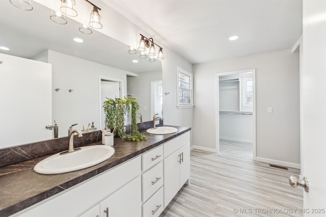 18446 E 112th St, Owasso, OK 74055 - bathroom featuring a sink, baseboards, double vanity, and recessed lighting