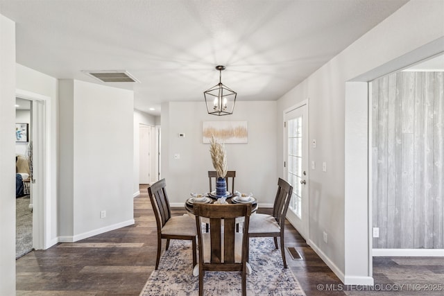 18446 E 112th St, Owasso, OK 74055 - dining space featuring dark wood-style flooring, visible vents, baseboards, and a notable chandelier