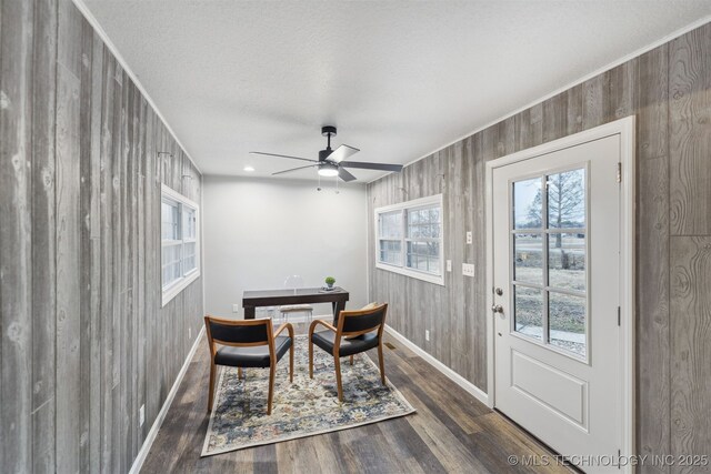 18446 E 112th St, Owasso, OK 74055 - dining area featuring ceiling fan, wood finished floors, wood walls, and baseboards