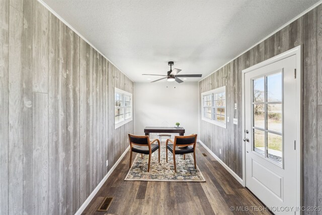 18446 E 112th St, Owasso, OK 74055 - dining space with ceiling fan, visible vents, wood finished floors, wooden walls, and baseboards