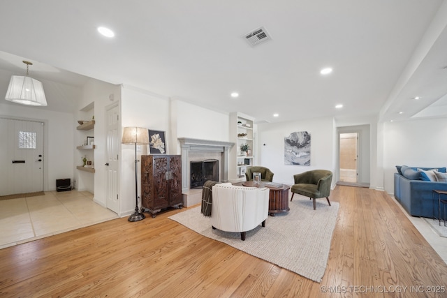 2947 S Peoria Ave, Tulsa, OK 74114 - living room with light wood finished floors, visible vents, recessed lighting, and built in features
