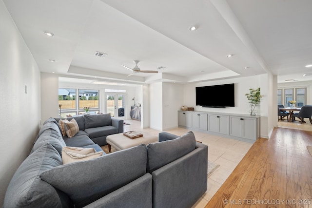 2947 S Peoria Ave, Tulsa, OK 74114 - living area with a raised ceiling, visible vents, a ceiling fan, and baseboards