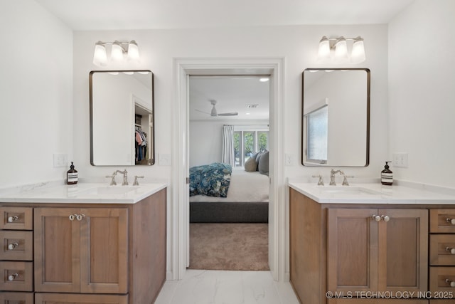 2947 S Peoria Ave, Tulsa, OK 74114 - ensuite bathroom featuring marble finish floor, two vanities, and a sink