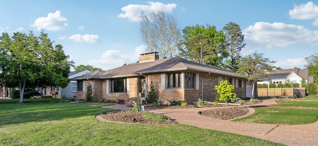 2947 S Peoria Ave, Tulsa, OK 74114 - view of front of home featuring fence, a chimney, brick siding, and a front yard
