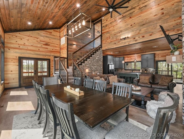 1739 NW 136th Rd, Wilburton, OK 74578 - dining space featuring plenty of natural light, stairs, wooden walls, and wooden ceiling