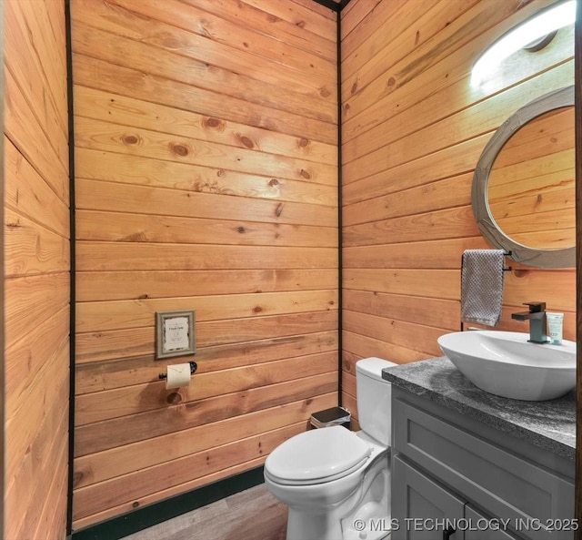1739 NW 136th Rd, Wilburton, OK 74578 - bathroom featuring wood finished floors, wooden walls, toilet, and vanity