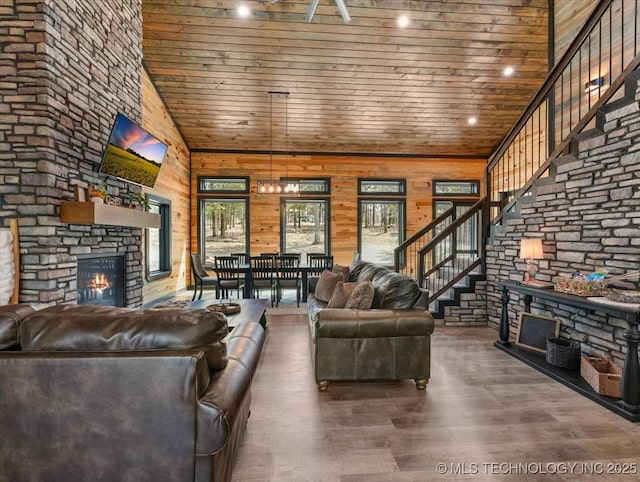 1739 NW 136th Rd, Wilburton, OK 74578 - unfurnished living room featuring stairway, wood ceiling, a towering ceiling, a fireplace, and wood finished floors