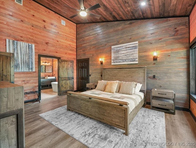 1739 NW 136th Rd, Wilburton, OK 74578 - bedroom with high vaulted ceiling, wooden ceiling, wood walls, and wood finished floors