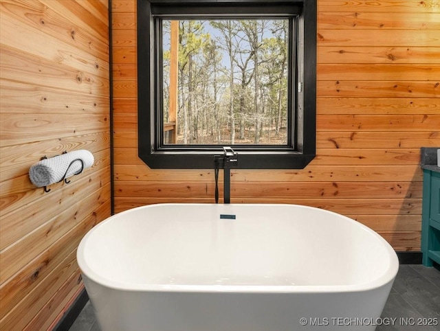 1739 NW 136th Rd, Wilburton, OK 74578 - bathroom with a soaking tub, wooden walls, and vanity