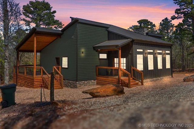 1739 NW 136th Rd, Wilburton, OK 74578 - view of front of home with a chimney, metal roof, and board and batten siding