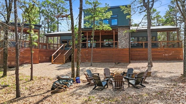 1739 NW 136th Rd, Wilburton, OK 74578 - view of playground featuring an outdoor fire pit, a sunroom, and stairway