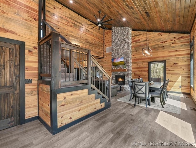 1739 NW 136th Rd, Wilburton, OK 74578 - stairs featuring a ceiling fan, wood ceiling, wood walls, and wood finished floors
