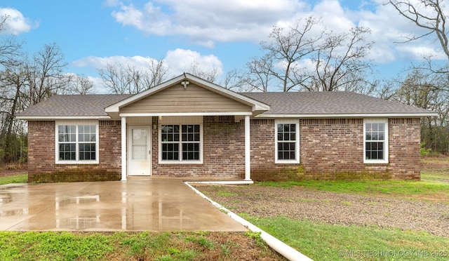 464888 E 1010th Rd, Sallisaw, OK 74955 - ranch-style house featuring brick siding, a shingled roof, and a patio area
