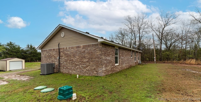 464888 E 1010th Rd, Sallisaw, OK 74955 - view of home's exterior with central AC, an outbuilding, a yard, a detached garage, and brick siding