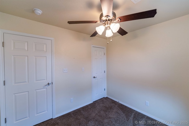 464888 E 1010th Rd, Sallisaw, OK 74955 - spare room with ceiling fan, dark colored carpet, and baseboards