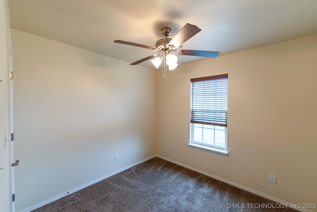 464888 E 1010th Rd, Sallisaw, OK 74955 - unfurnished room with dark carpet, baseboards, and a ceiling fan