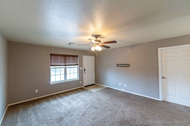 464888 E 1010th Rd, Sallisaw, OK 74955 - carpeted spare room featuring visible vents, baseboards, a textured ceiling, and ceiling fan
