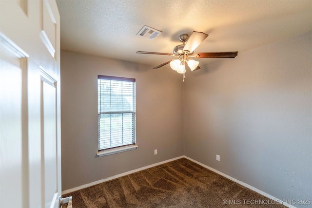 464888 E 1010th Rd, Sallisaw, OK 74955 - spare room with visible vents, baseboards, dark carpet, a ceiling fan, and a textured ceiling