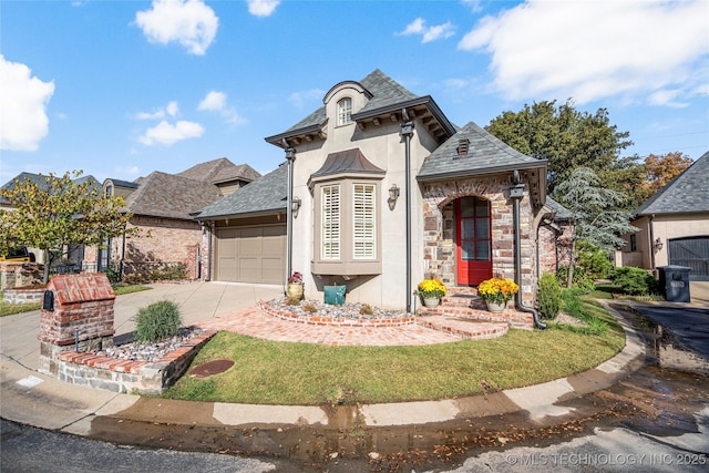 6323 E 111th Pl, Tulsa, OK 74137 - french provincial home with stucco siding, a garage, driveway, stone siding, and a shingled roof