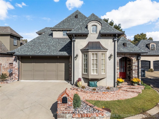 6323 E 111th Pl, Tulsa, OK 74137 - french country style house with stucco siding, concrete driveway, an attached garage, and roof with shingles