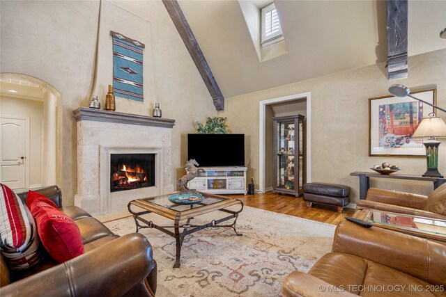 6323 E 111th Pl, Tulsa, OK 74137 - living room with high vaulted ceiling, a skylight, wood finished floors, and a tiled fireplace