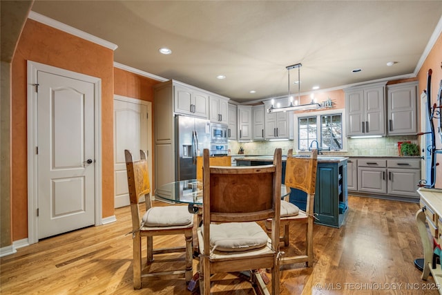6323 E 111th Pl, Tulsa, OK 74137 - kitchen featuring a kitchen island, light wood-type flooring, stainless steel appliances, gray cabinets, and crown molding