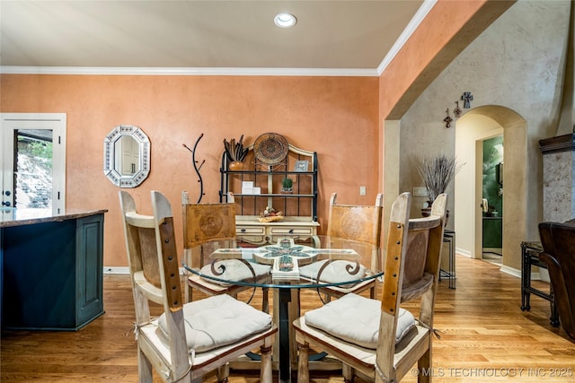 6323 E 111th Pl, Tulsa, OK 74137 - dining room featuring light wood-type flooring, arched walkways, and crown molding