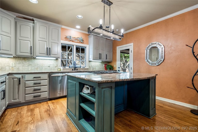 6323 E 111th Pl, Tulsa, OK 74137 - kitchen with stainless steel appliances, a kitchen island, ornamental molding, backsplash, and light wood-style flooring