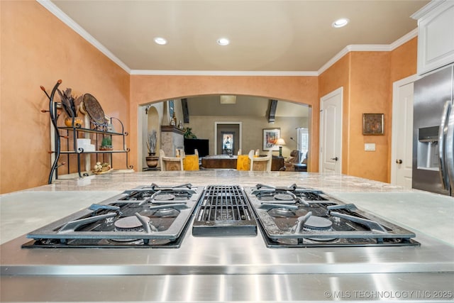 6323 E 111th Pl, Tulsa, OK 74137 - kitchen featuring arched walkways, stainless steel fridge, ornamental molding, stovetop with downdraft, and recessed lighting