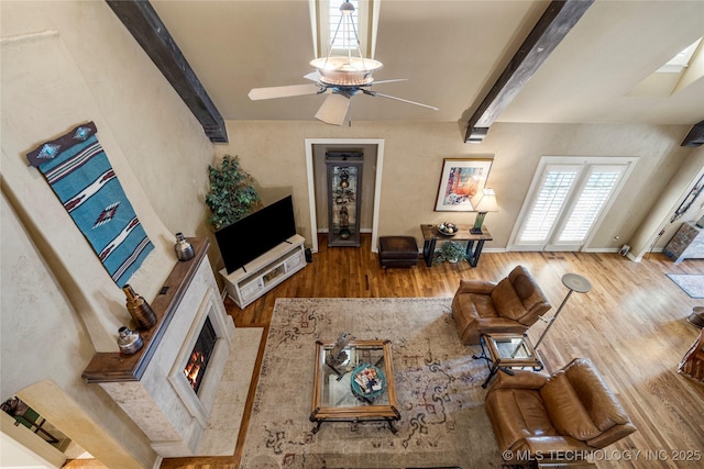 6323 E 111th Pl, Tulsa, OK 74137 - living room with wood finished floors, beam ceiling, ceiling fan, and a premium fireplace