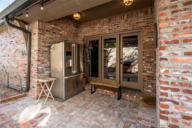 6323 E 111th Pl, Tulsa, OK 74137 - view of exterior entry with french doors and brick siding