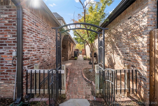 6323 E 111th Pl, Tulsa, OK 74137 - view of property exterior featuring a gate and brick siding