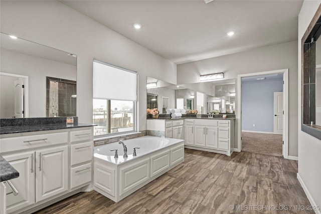 3316 W Jackson St, Broken Arrow, OK 74012 - bathroom with recessed lighting, vanity, wood finished floors, and a garden tub