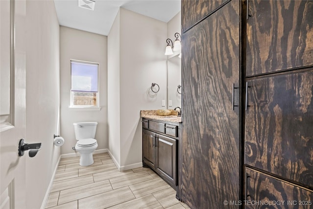 3316 W Jackson St, Broken Arrow, OK 74012 - bathroom with visible vents, baseboards, toilet, wood tiled floor, and vanity