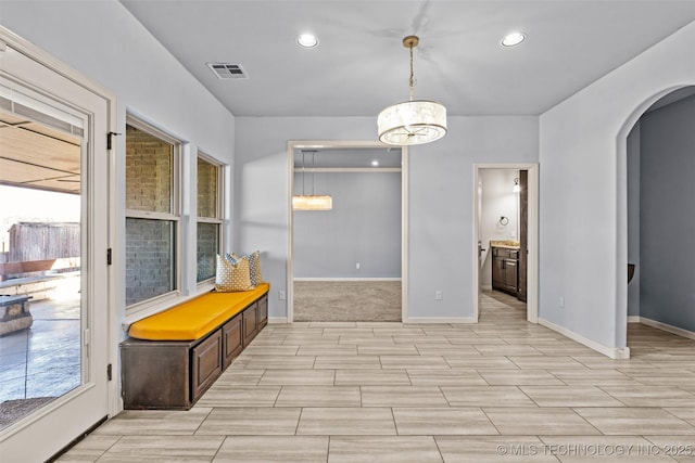 3316 W Jackson St, Broken Arrow, OK 74012 - unfurnished dining area with arched walkways, wood tiled floors, recessed lighting, and a chandelier