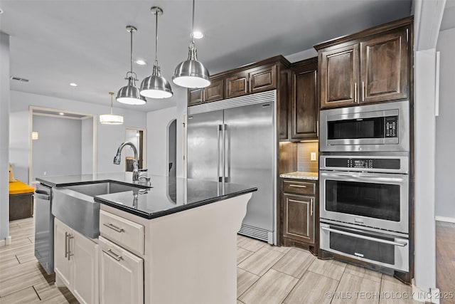 3316 W Jackson St, Broken Arrow, OK 74012 - kitchen featuring recessed lighting, built in appliances, a sink, and dark brown cabinets