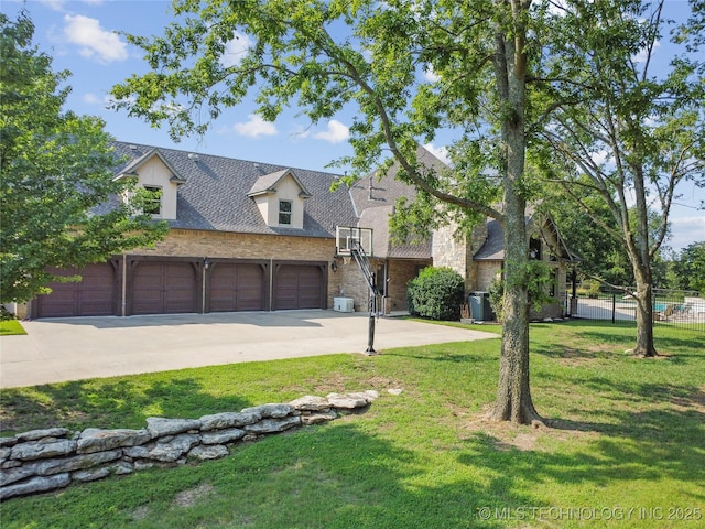 cape cod house featuring a front lawn, roof with shingles, fence, and concrete driveway
