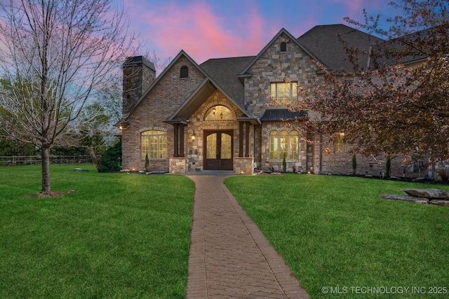 9931 N Chadford Rd, Owasso, OK 74055 - view of front of property with french doors, stone siding, and a chimney