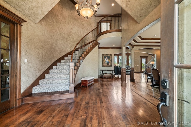 9931 N Chadford Rd, Owasso, OK 74055 - entrance foyer with crown molding, a high ceiling, stairway, hardwood / wood-style floors, and decorative columns