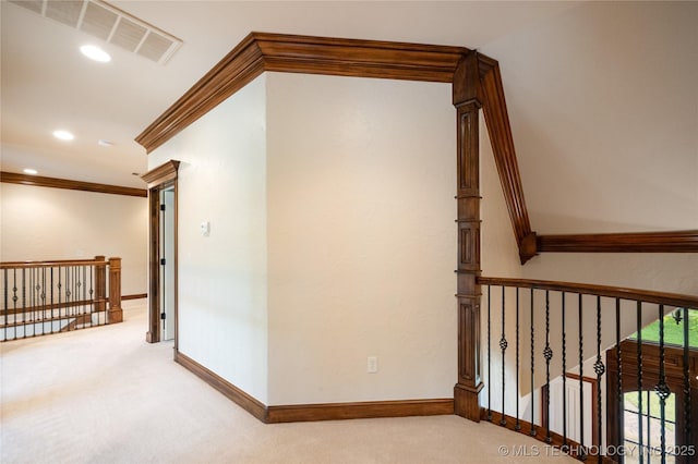hallway featuring visible vents, ornamental molding, baseboards, recessed lighting, and carpet flooring
