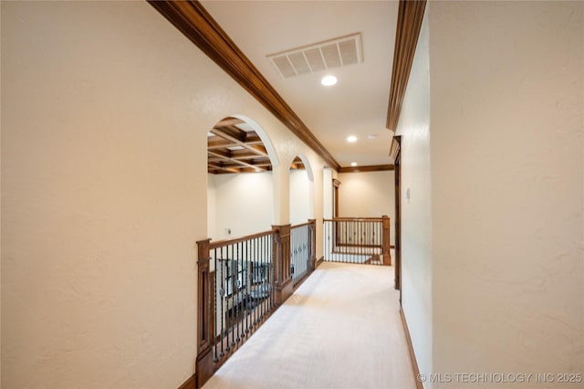 corridor with beam ceiling, arched walkways, recessed lighting, visible vents, and ornamental molding