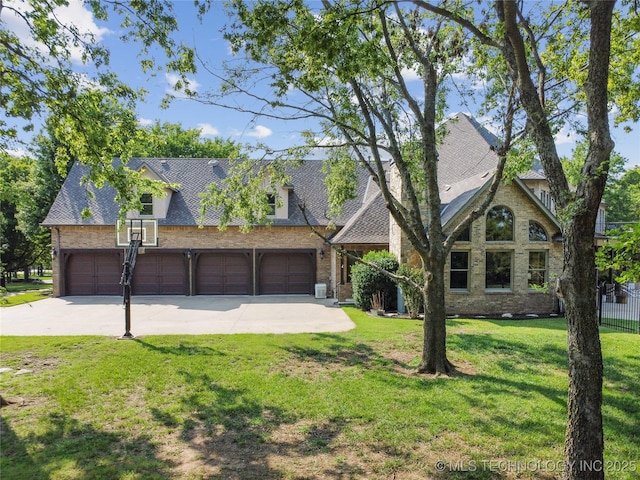 view of front facade featuring fence, driveway, a front lawn, and brick siding