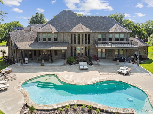 outdoor pool with a patio and fence