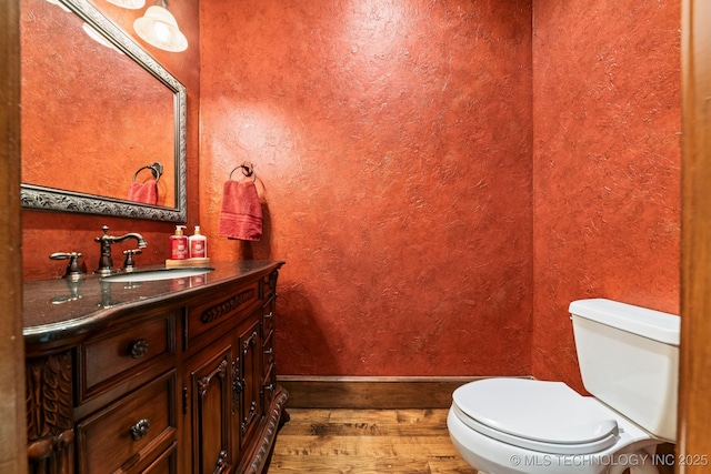 9931 N Chadford Rd, Owasso, OK 74055 - half bathroom with wood finished floors, vanity, and a textured wall