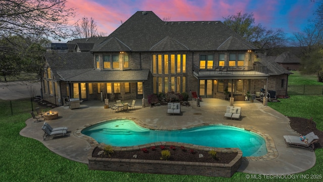 9931 N Chadford Rd, Owasso, OK 74055 - rear view of property with a balcony, a fire pit, a patio, and a fenced backyard
