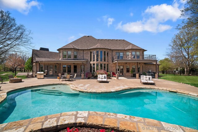 9931 N Chadford Rd, Owasso, OK 74055 - view of swimming pool with a patio and an outdoor fire pit